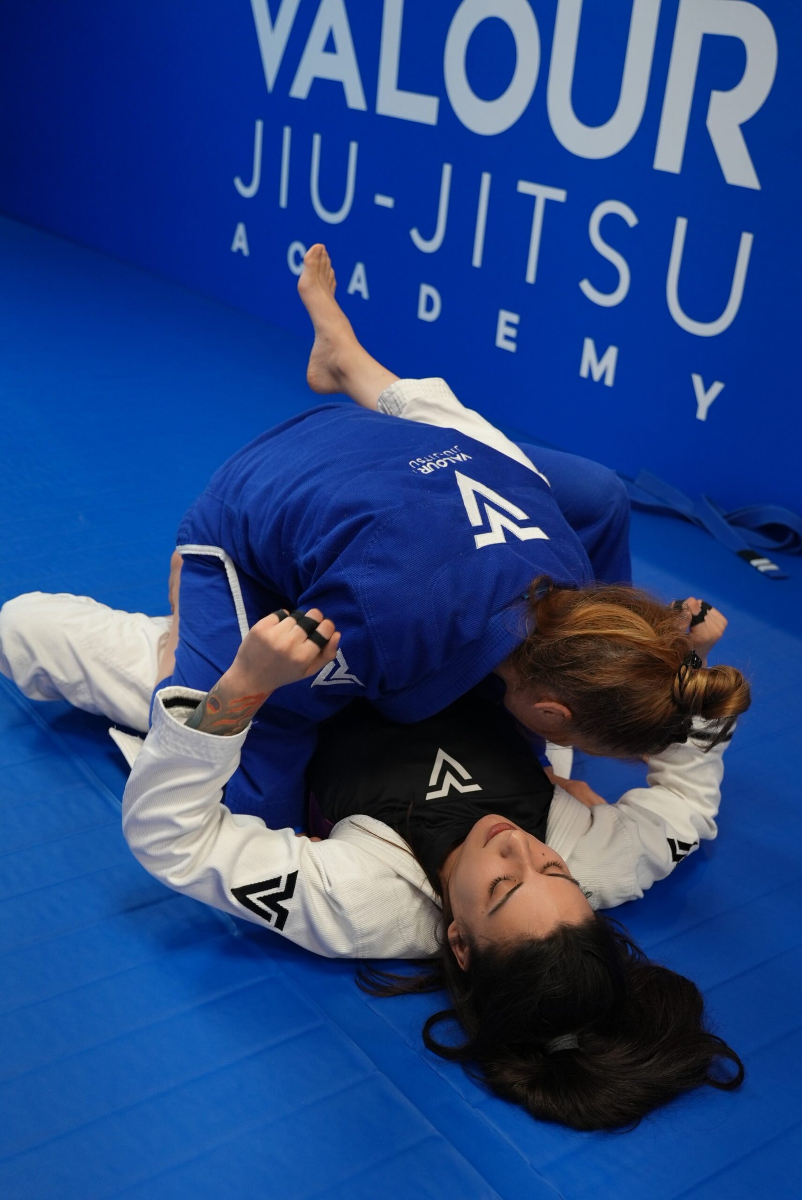 Women practicing Brazilian Jiu-Jitsu sparring during a women-only training class at Valour Jiu-Jitsu Academy.