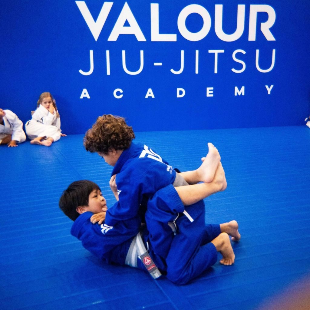 Children practising Brazilian Jiu-Jitsu during a kids class at Valour Jiu-Jitsu Academy, developing confidence, discipline, and teamwork in a safe and supportive environment.