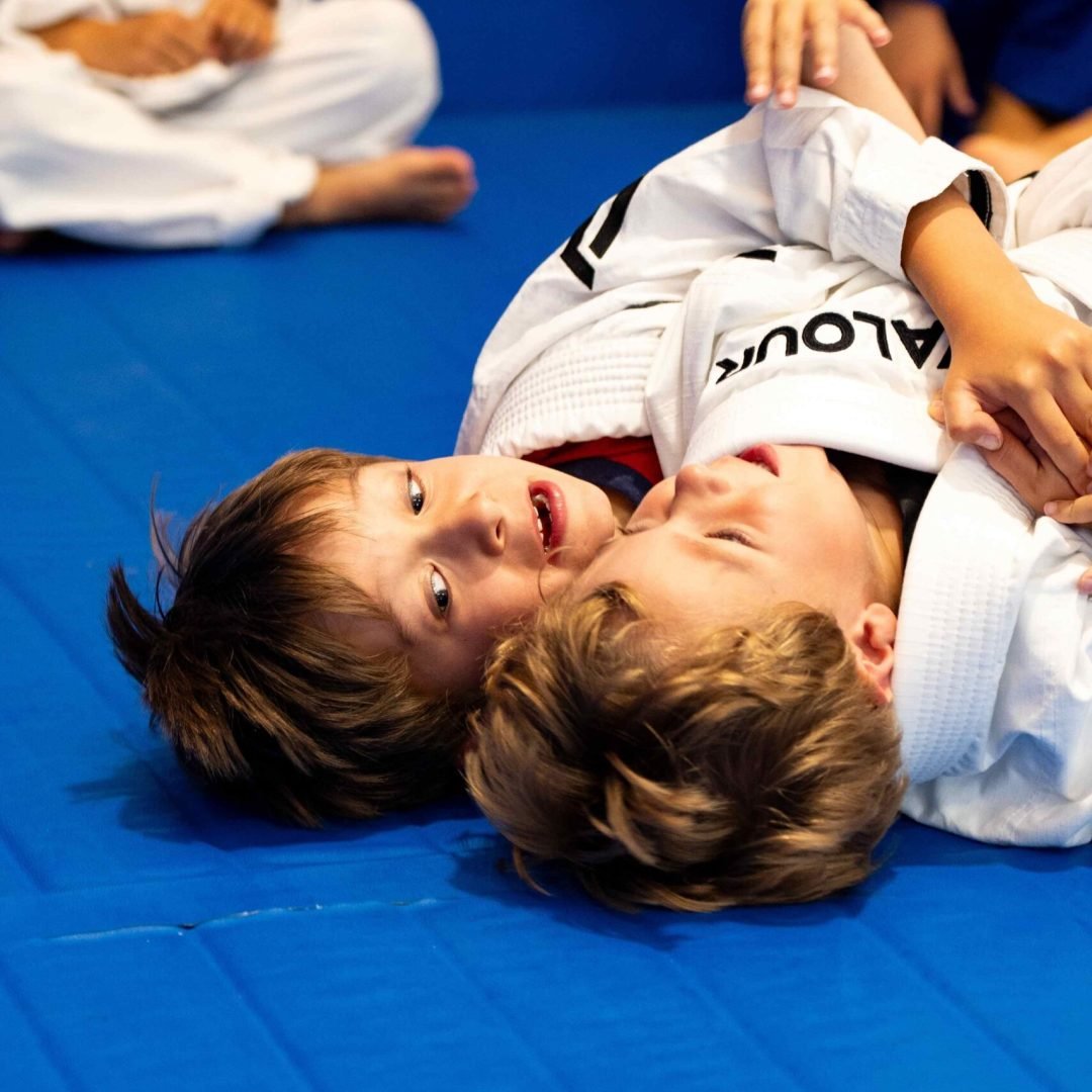 Children practising Brazilian Jiu-Jitsu during a kids class at Valour Jiu-Jitsu Academy, developing confidence, discipline, and teamwork in a safe and supportive environment.